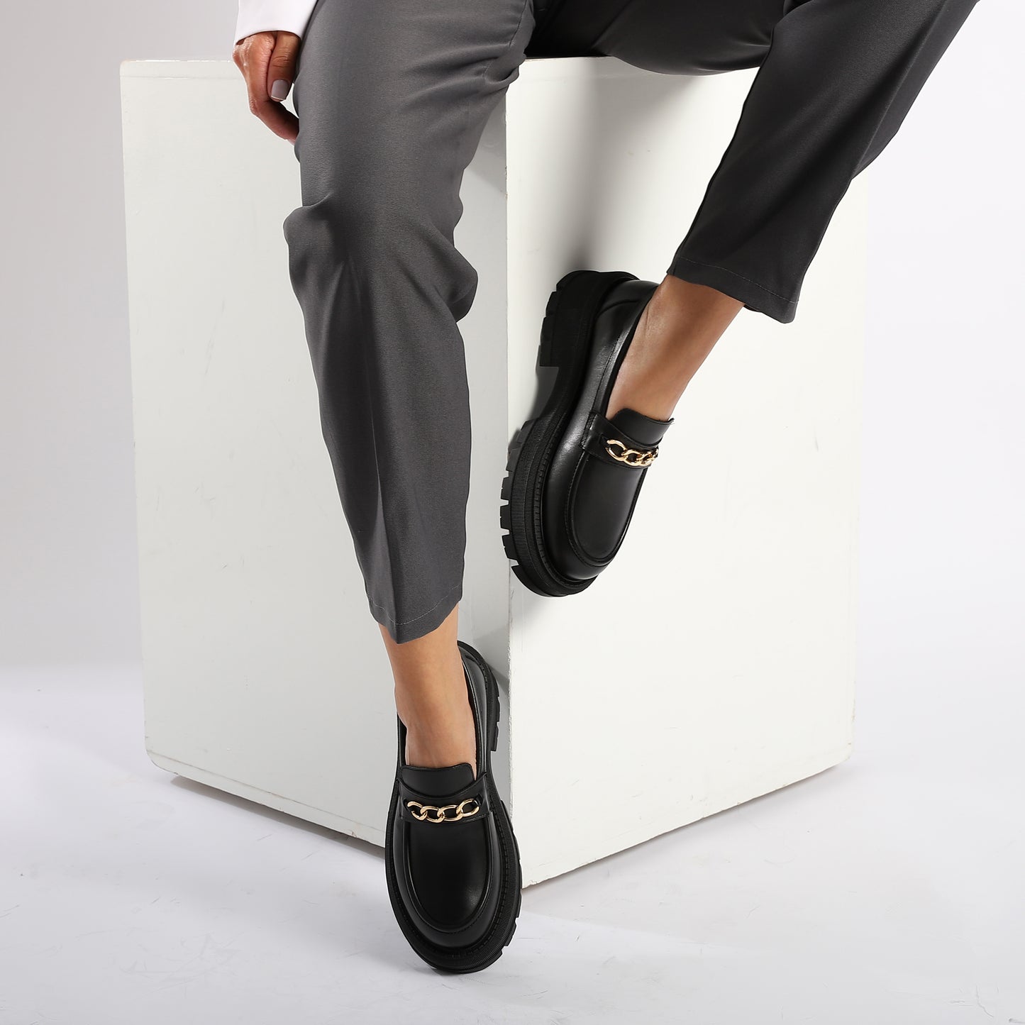 Comfortable black leather loafers with bold chain design and chunky sole